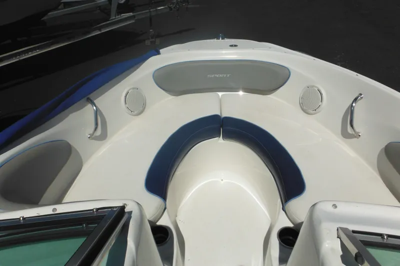 Slide: The Image of 2011 Sea Ray 205 Sport boat interior with blue and white seating. - 20