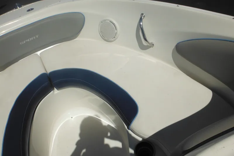 Slide: The Image of 2011 Sea Ray 205 Sport boat interior with cushioned seating and speaker. - 23