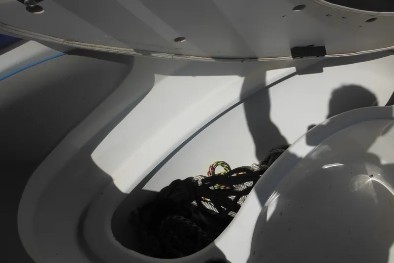 Slide: The Image of Open storage compartment on 2011 Sea Ray 205 Sport boat with ropes inside. - 28