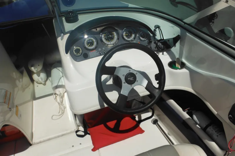 Slide: The Image of 2011 Sea Ray 205 Sport boat dashboard with steering wheel and gauges. - 30