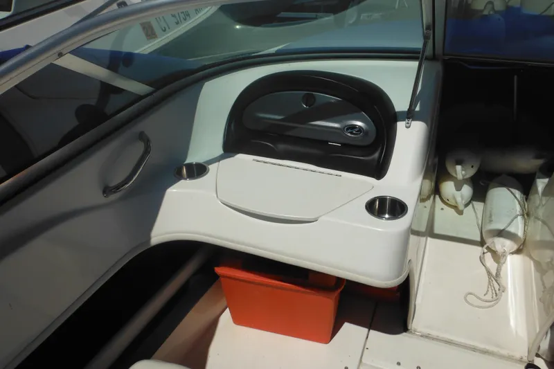 Slide: The Image of 2011 Sea Ray 205 Sport boat interior with steering wheel and cup holders. - 31