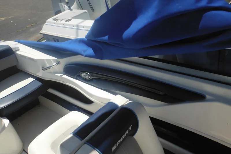 Slide: The Image of Interior of a 2011 Sea Ray 205 Sport boat with blue and white seating. - 34