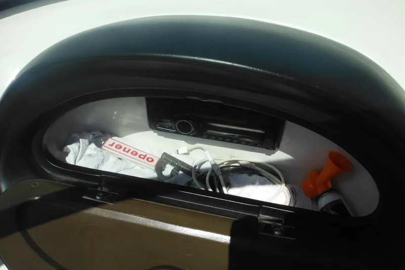 Slide: The Image of Storage compartment in a 2011 Sea Ray 205 Sport boat with various items. - 35