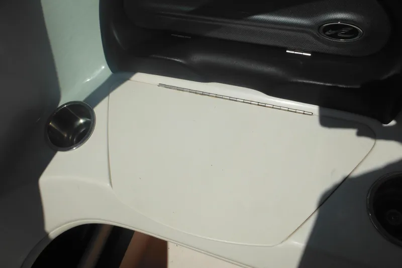 Slide: The Image of Interior view of a 2011 Sea Ray 205 Sport boat, featuring cup holders and seating area. - 36