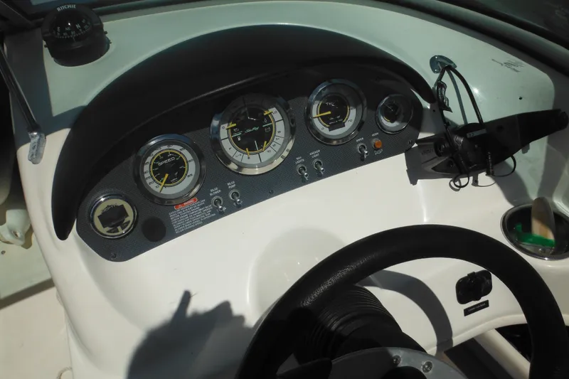 Slide: The Image of Dashboard of a 2011 Sea Ray 205 Sport boat with gauges and steering wheel. - 38