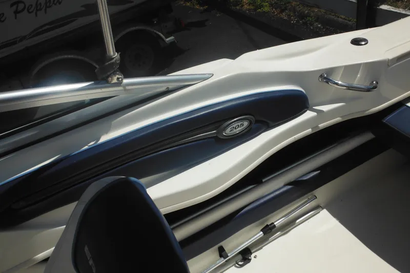 Slide: The Image of 2011 Sea Ray 205 Sport boat interior with blue and white design elements. - 40