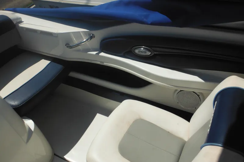 Slide: The Image of Interior of a 2011 Sea Ray 205 Sport boat, featuring seating and speaker. - 41