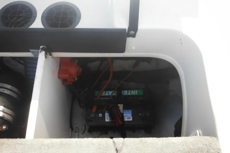 Slide: The Image of 2011 Sea Ray 205 Sport boat battery compartment with visible wiring and ventilation. - 42