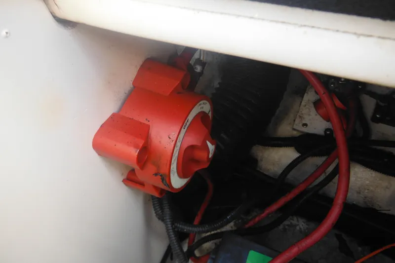 Slide: The Image of Red battery switch in a 2011 Sea Ray 205 Sport boat engine compartment. - 43