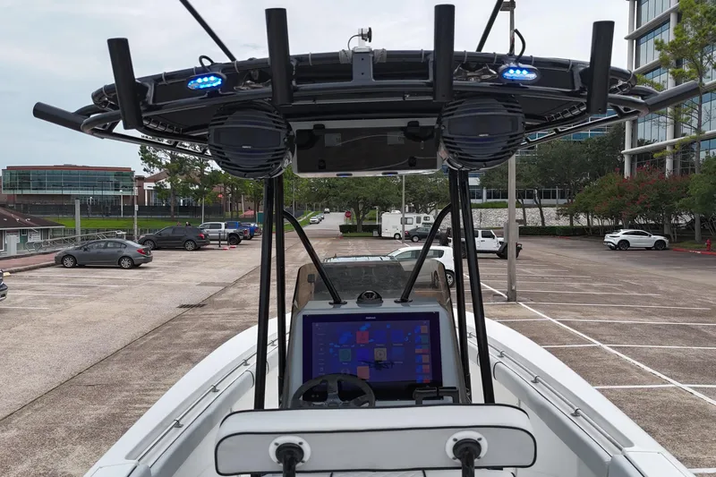 Slide: The Image of 1999 Contender 23 Open boat with advanced navigation system in a parking lot. - 12