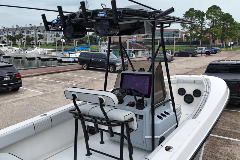 Slide: The Image of 1999 Contender 23 Open boat with modern console, docked near marina. - 14