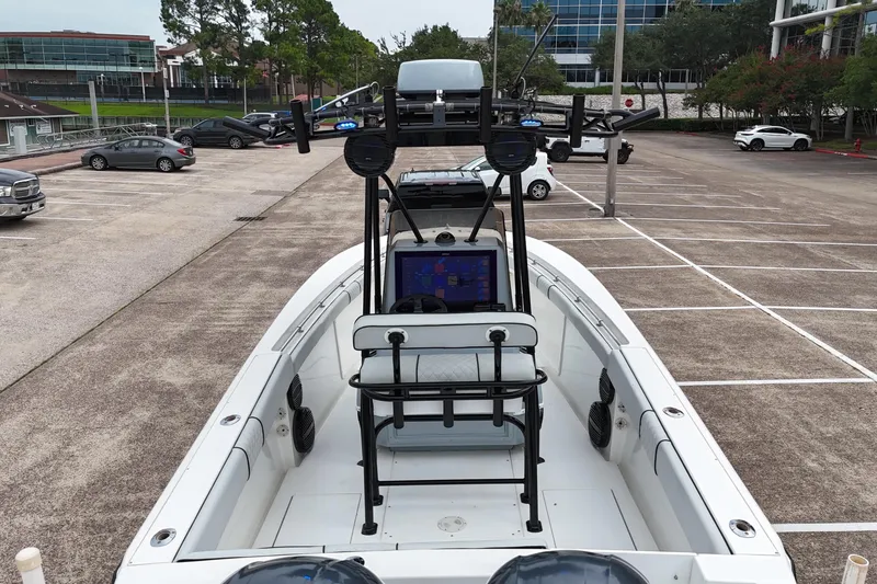 Slide: The Image of 1999 Contender 23 Open boat in parking lot, featuring modern navigation equipment. - 15