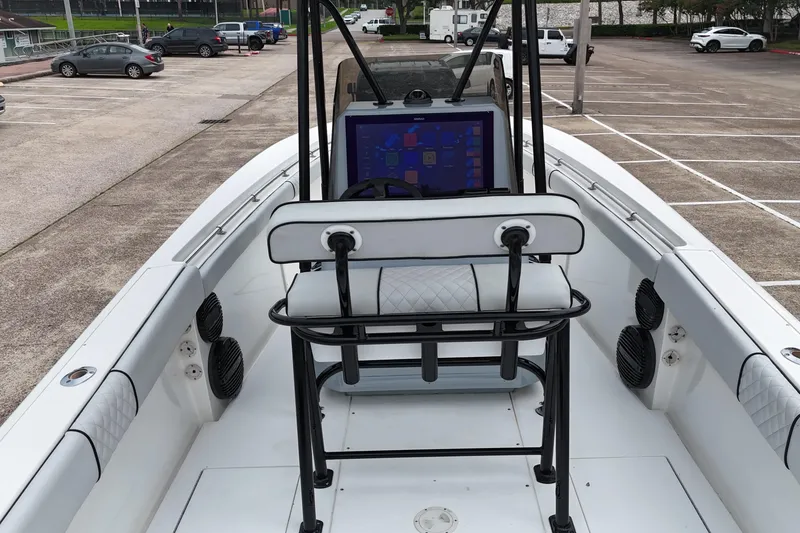 Slide: The Image of 1999 Contender 23 Open boat interior with modern navigation system in a parking lot. - 17