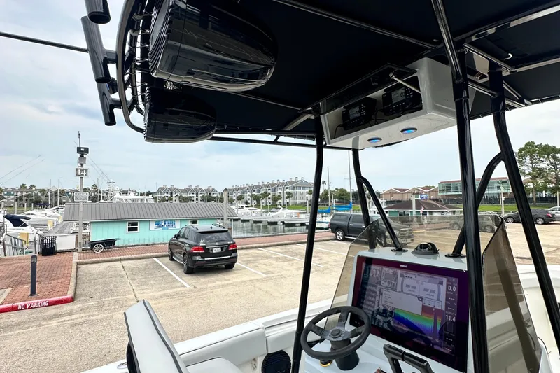 Slide: The Image of 1999 Contender 23 Open boat dashboard with navigation equipment at a marina. - 25