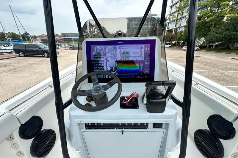 Slide: The Image of Center console of a 1999 Contender 23 Open boat with modern navigation equipment. - 33