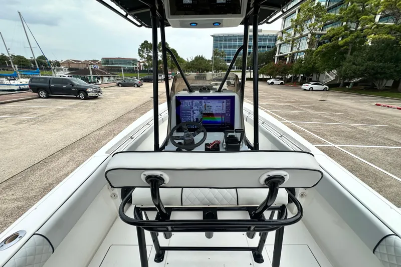 Slide: The Image of 1999 Contender 23 Open boat interior with navigation system, parked in a marina lot. - 34