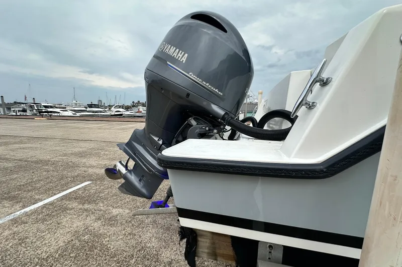 Slide: The Image of 1999 Contender 23 Open boat with Yamaha outboard motor at marina dock. - 35