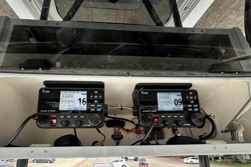 Slide: The Image of Dual Icom marine radios on a 1999 Contender 23 Open boat dashboard. - 36