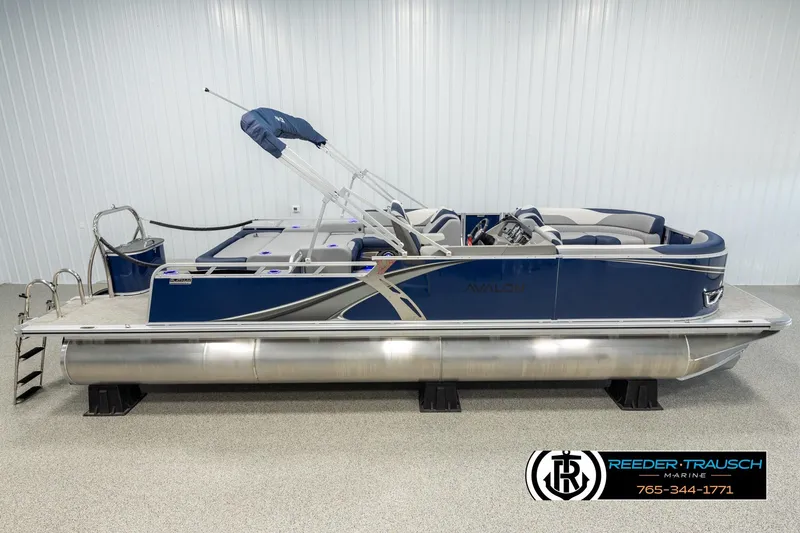 The Image of 2026 Avalon LSZ VRB pontoon boat in showroom, featuring sleek blue design and modern amenities. - 1