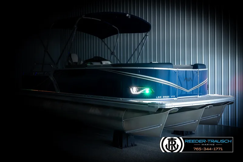 Slide: The Image of 2026 Avalon LSZ VRB pontoon boat in a dimly lit showroom. - 4