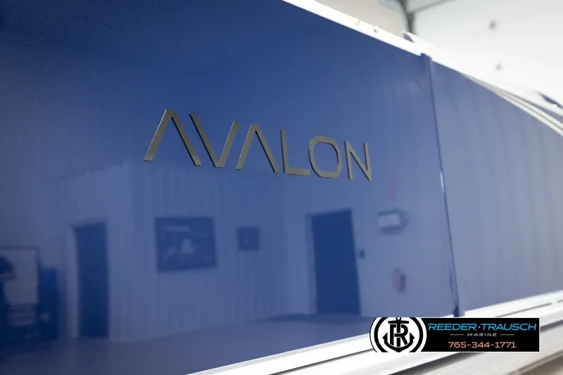 Slide: The Image of 2026 Avalon LSZ VRB boat with sleek blue exterior, Reeder-Trausch Marine logo visible. - 48