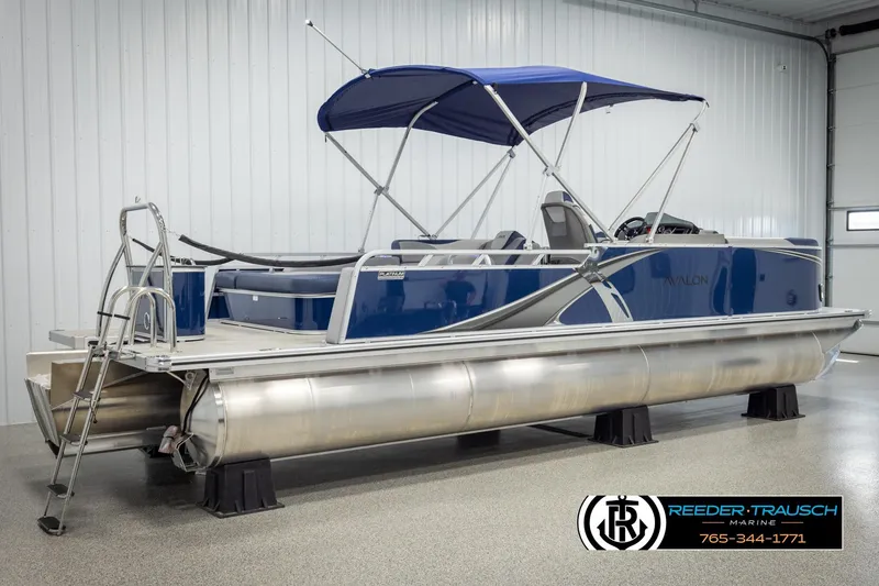 Slide: The Image of 2026 Avalon LSZ VRB pontoon boat with blue canopy in showroom. - 6