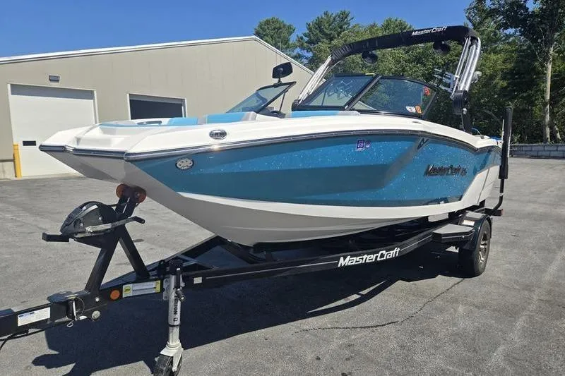 Slide: The Image of 2020 MasterCraft NXT20 boat on trailer, parked outdoors near a building. - 18