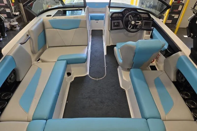 Slide: The Image of 2020 MasterCraft NXT20 boat interior with blue and white seating, modern dashboard. - 7
