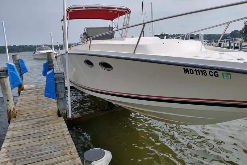 Slide: The Image of 1990 Donzi F-33 boat docked with red canopy, side view. - 1