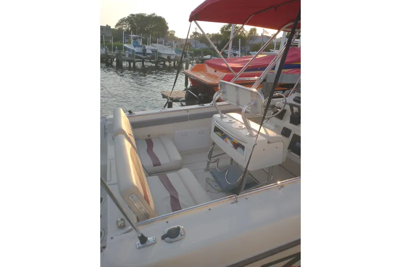 Slide: The Image of 1990 Donzi F-33 boat interior with seating and helm, docked at marina. - 5