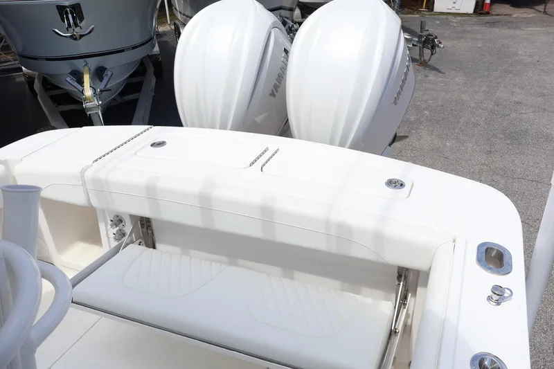 Slide: The Image of 2026 Regulator 25 boat with dual outboard engines, white seating, and sleek design. - 14