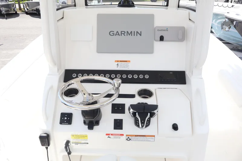 Slide: The Image of 2026 Regulator 25 boat dashboard with Garmin navigation system and steering wheel. - 4