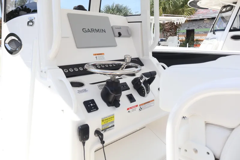Slide: The Image of 2026 Regulator 25 boat dashboard with Garmin navigation system and steering wheel. - 5