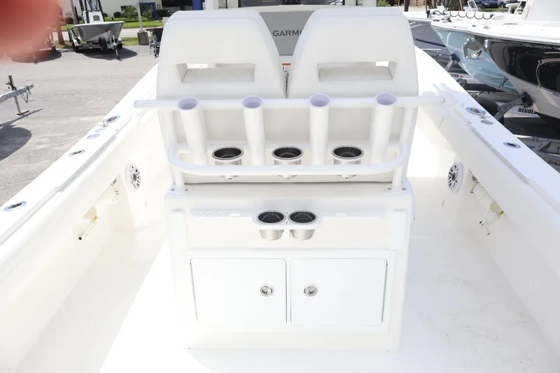Slide: The Image of 2026 Regulator 25 boat interior with rod holders and storage compartments. - 7