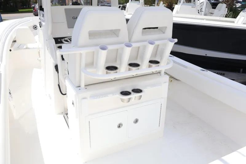 Slide: The Image of 2026 Regulator 25 boat interior with rod holders and storage compartments. - 8