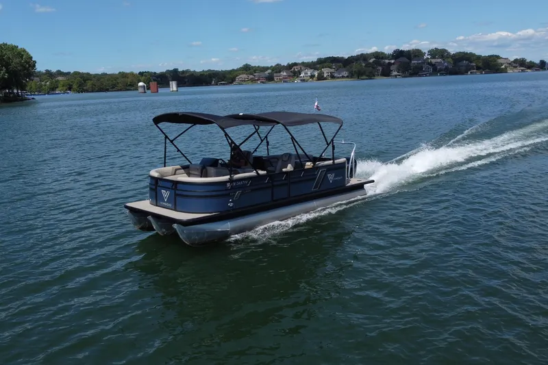 Slide: The Image of 2023 Viaggio 22U pontoon boat cruising on a scenic lake under a clear blue sky. - 0