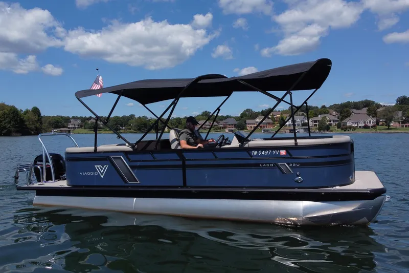 Slide: The Image of 2023 Viaggio 22U pontoon boat on a lake, under a clear blue sky. - 1
