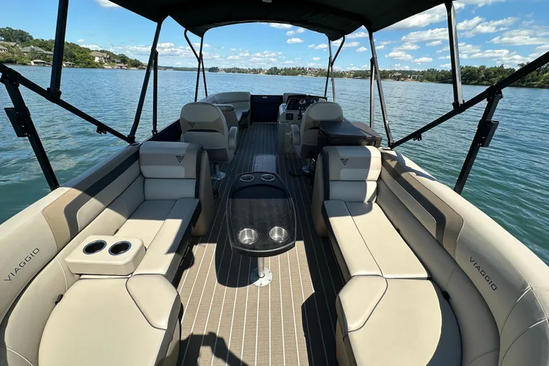 Slide: The Image of Luxurious 2023 Viaggio 22U pontoon boat interior with spacious seating on a serene lake. - 10