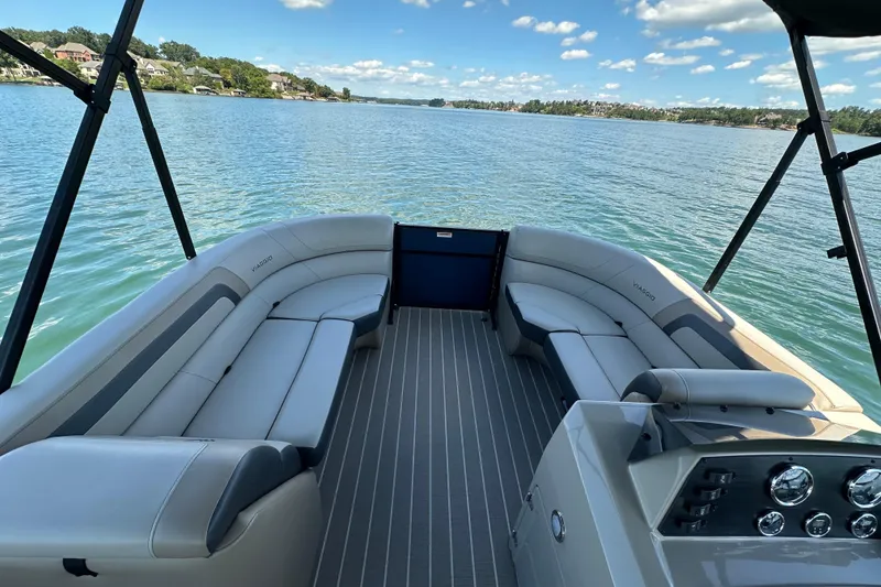 Slide: The Image of 2023 Viaggio 22U pontoon boat interior with spacious seating on a serene lake. - 12
