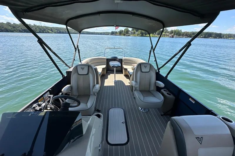 Slide: The Image of 2023 Viaggio 22U pontoon boat interior on a serene lake. - 16