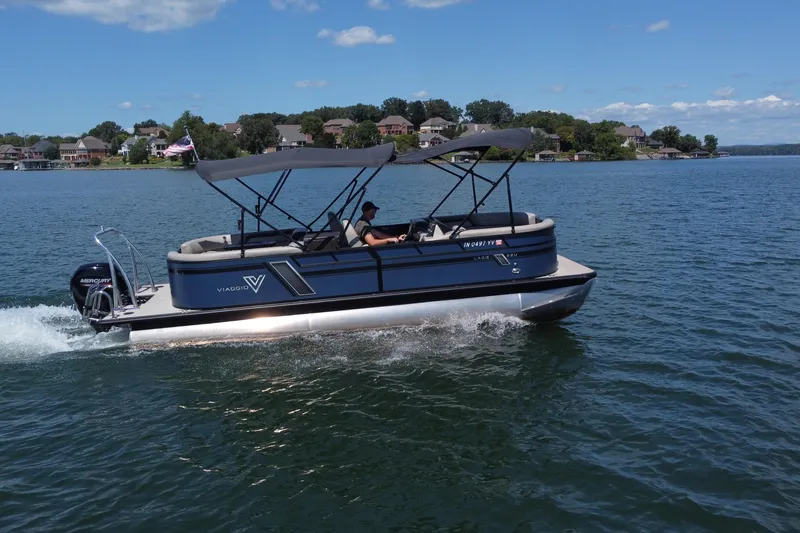 Slide: The Image of 2023 Viaggio 22U pontoon boat cruising on a lake under a clear blue sky. - 18