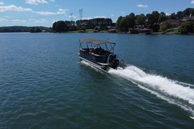 Slide: The Image of 2023 Viaggio 22U boat cruising on a scenic lake under a clear blue sky. - 3