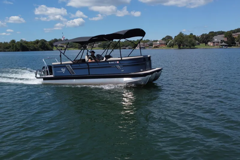 Slide: The Image of 2023 Viaggio 22U pontoon boat cruising on a scenic lake under a clear blue sky. - 4