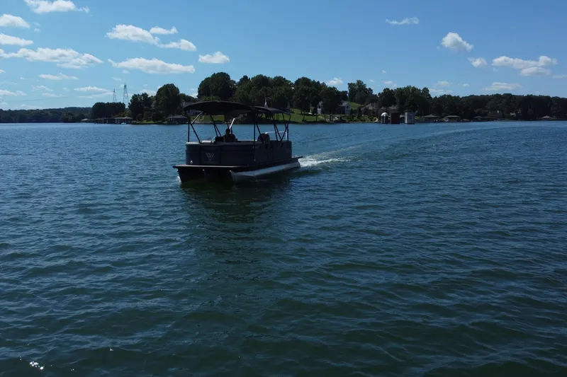 Slide: The Image of A 2023 Viaggio 22U boat cruising on a scenic lake under a clear blue sky. - 5