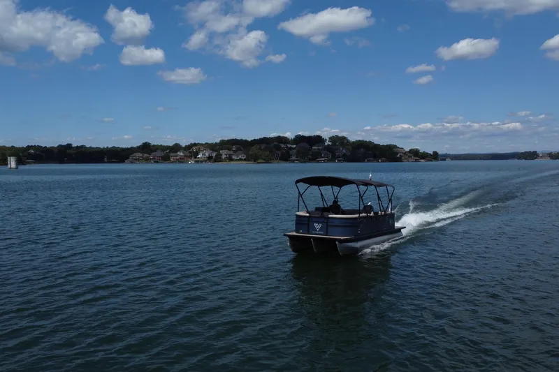Slide: The Image of 2023 Viaggio 22U pontoon boat cruising on a scenic lake under a blue sky. - 6