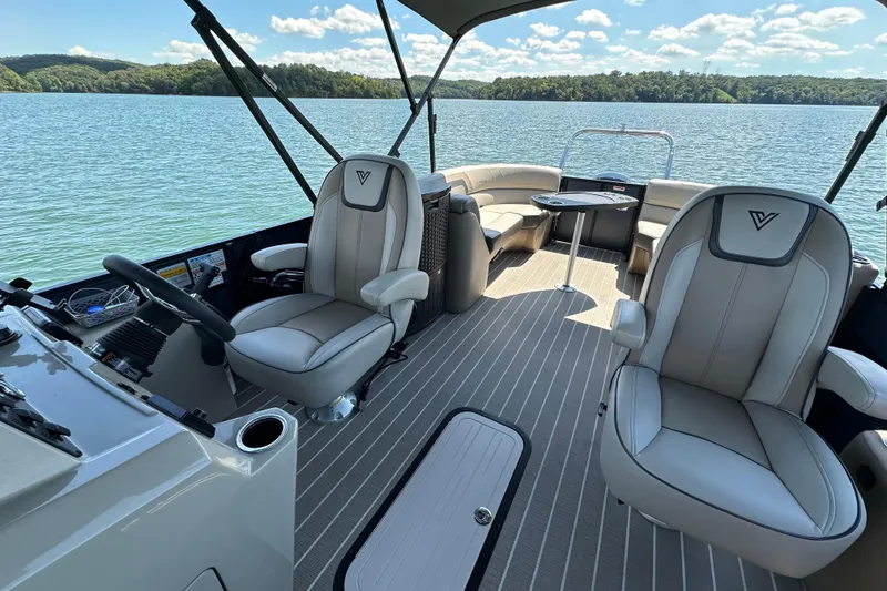 Slide: The Image of 2023 Viaggio 22U boat interior with plush seating on a serene lake. - 7