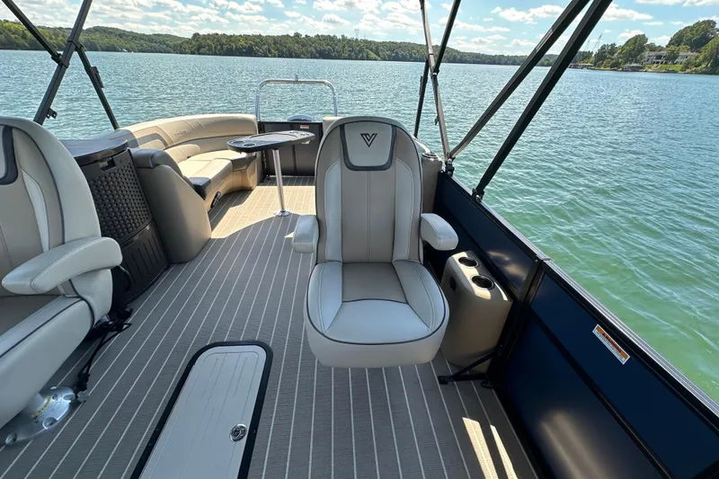 Slide: The Image of 2023 Viaggio 22U boat interior with luxurious seating on a serene lake. - 8