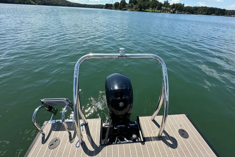 Slide: The Image of 2023 Viaggio 22U boat with outboard motor on a serene lake. - 9