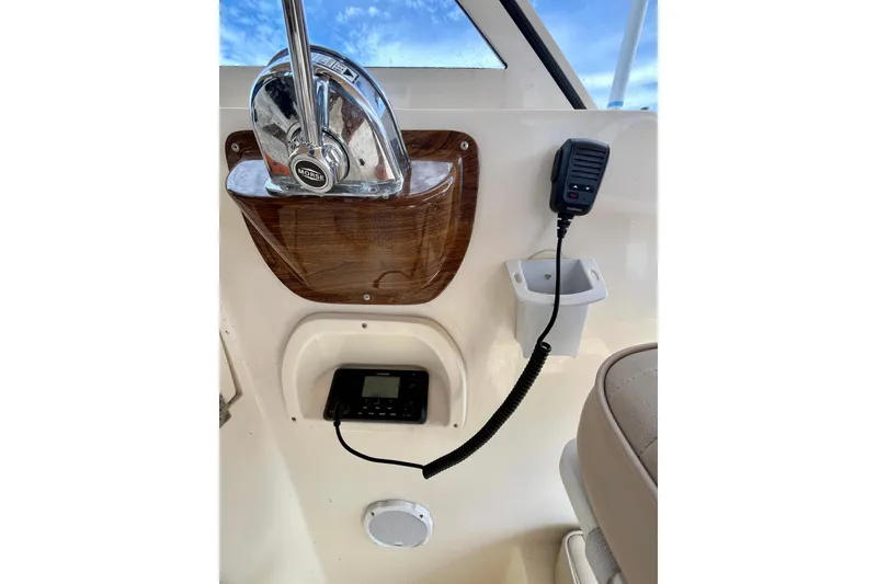 Slide: The Image of 2005 Mainship Pilot 30-II helm with controls, radio, and microphone. - 21