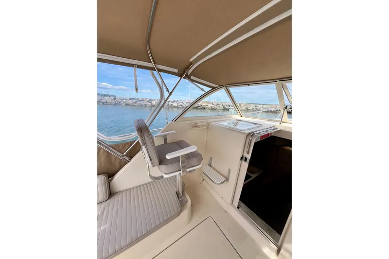 Slide: The Image of 2005 Mainship Pilot 30-II boat interior with helm seat and ocean view. - 24